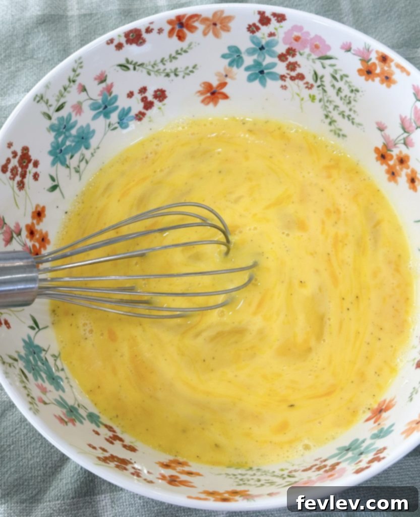 Grab-and-Go Breakfast Bites 4 Scrambled eggs cooking in a skillet with bacon grease
