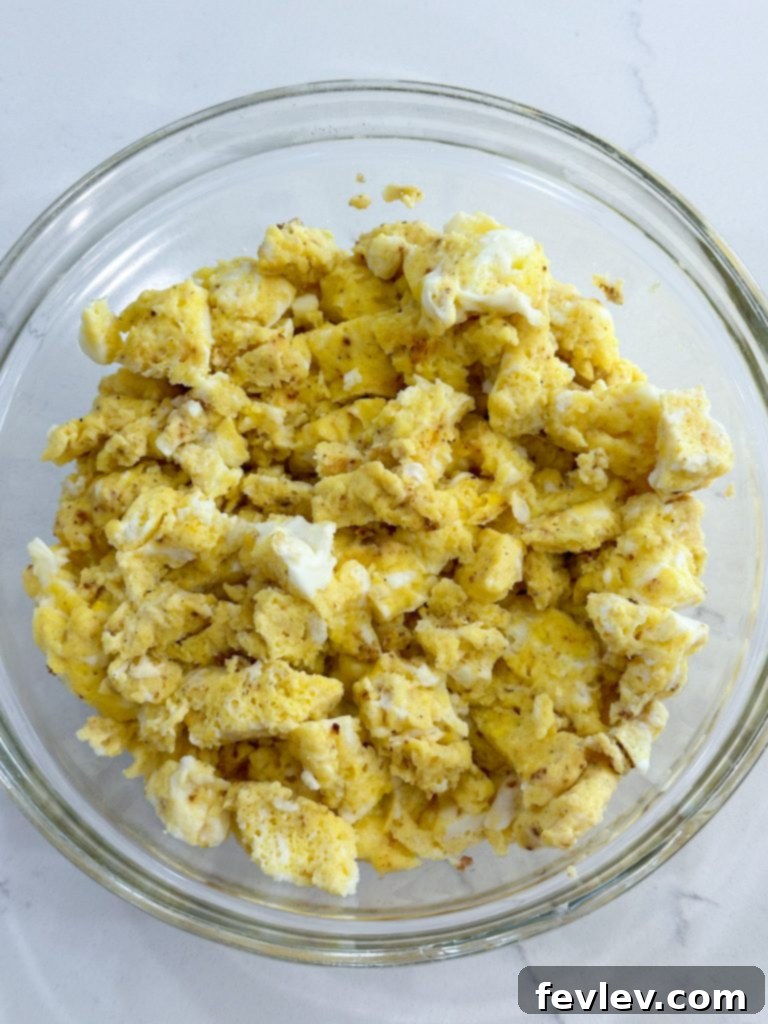 Grab-and-Go Breakfast Bites 5 Assembled breakfast sliders with layers of egg, bacon, and cheese