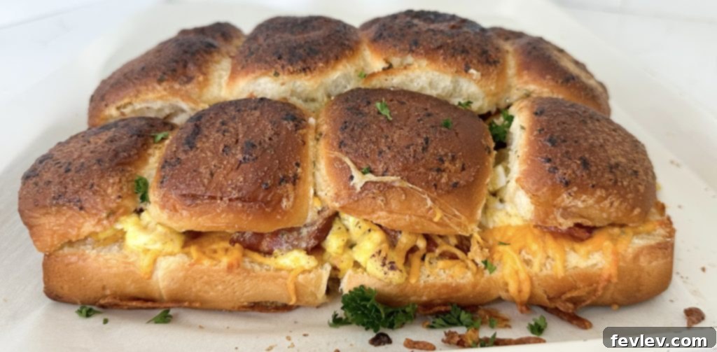Grab-and-Go Breakfast Bites 8 Close-up of baked breakfast sliders, showing the gooey cheese and layers