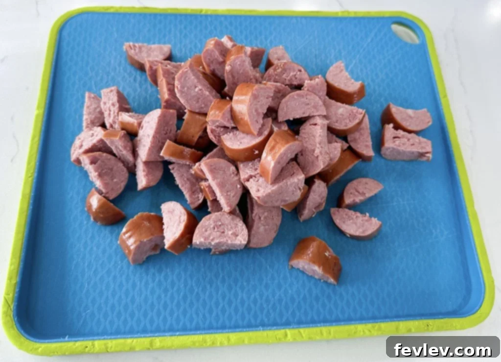 Sausage being cut into half-moon shapes