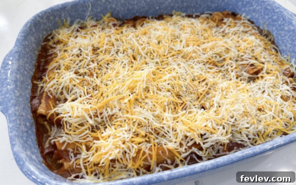 Lazy Day Taquito Bake 6 Taquito casserole baking in the oven with enchilada sauce