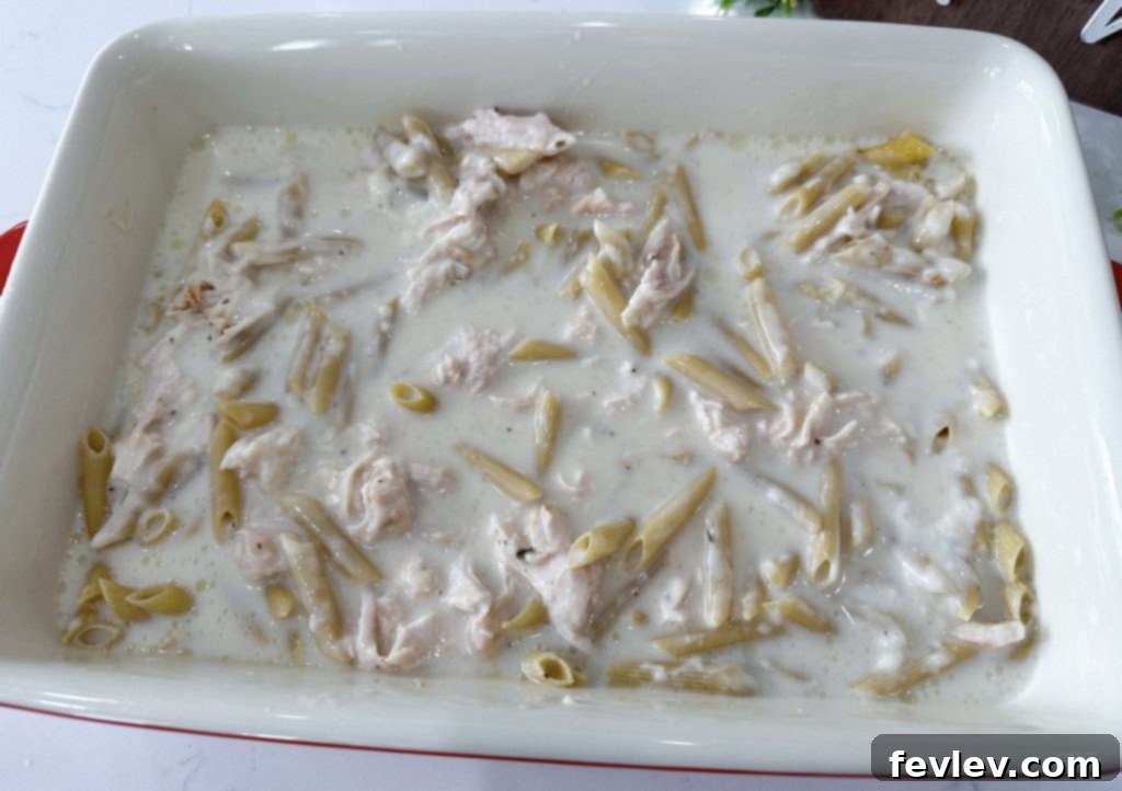 Combining ingredients for dump and go garlic chicken pasta casserole