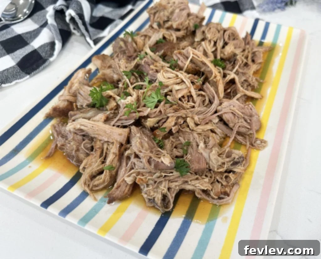 Leftover slow cooker apple cider pulled pork in an airtight container for storage