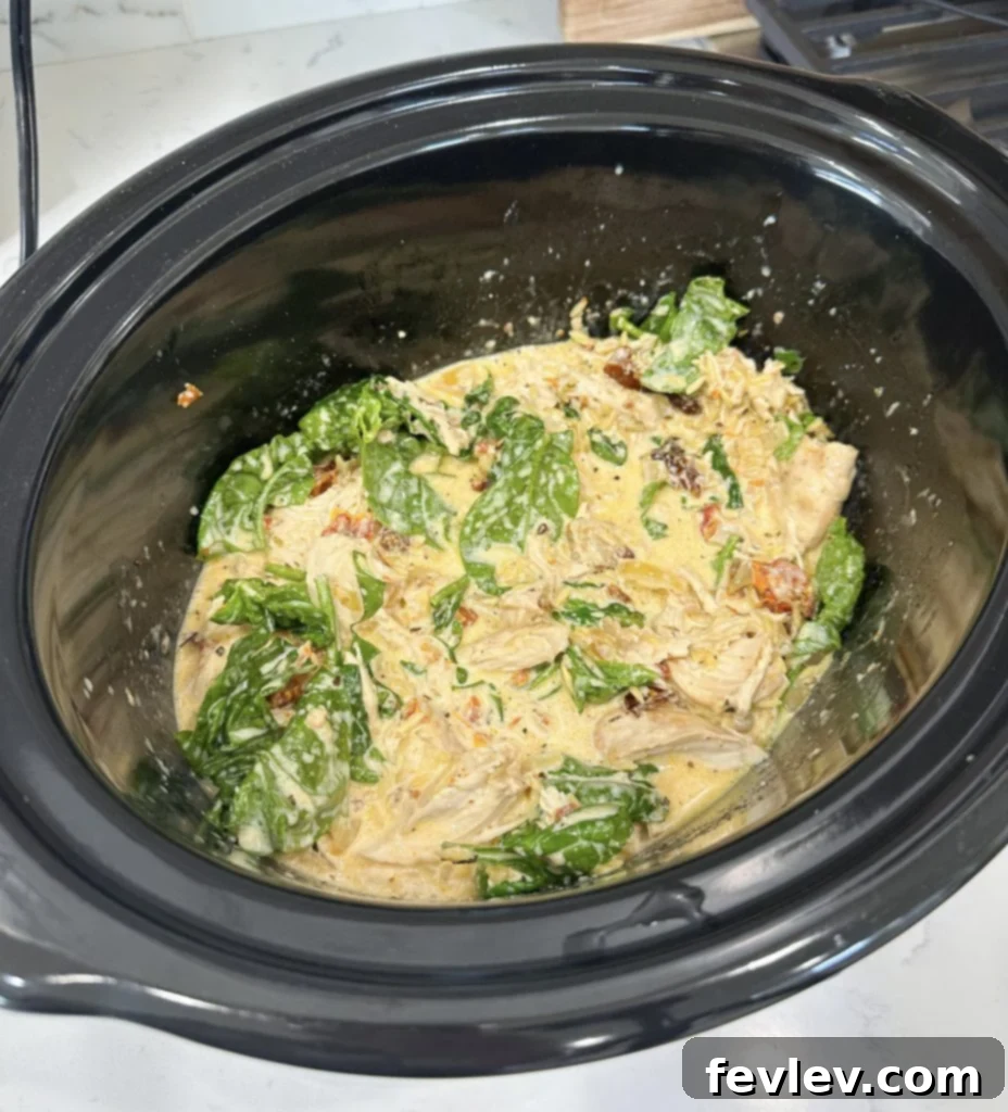 Orzo, heavy cream, and spinach added to slow cooker