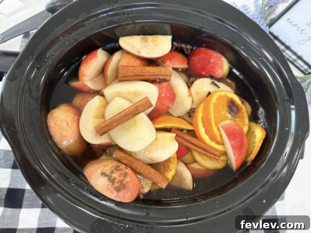 Cozy Slow Cooker Apple Cider 5 Close-up of the rich, spiced slow cooker apple cider in the crockpot, showing infused flavors.