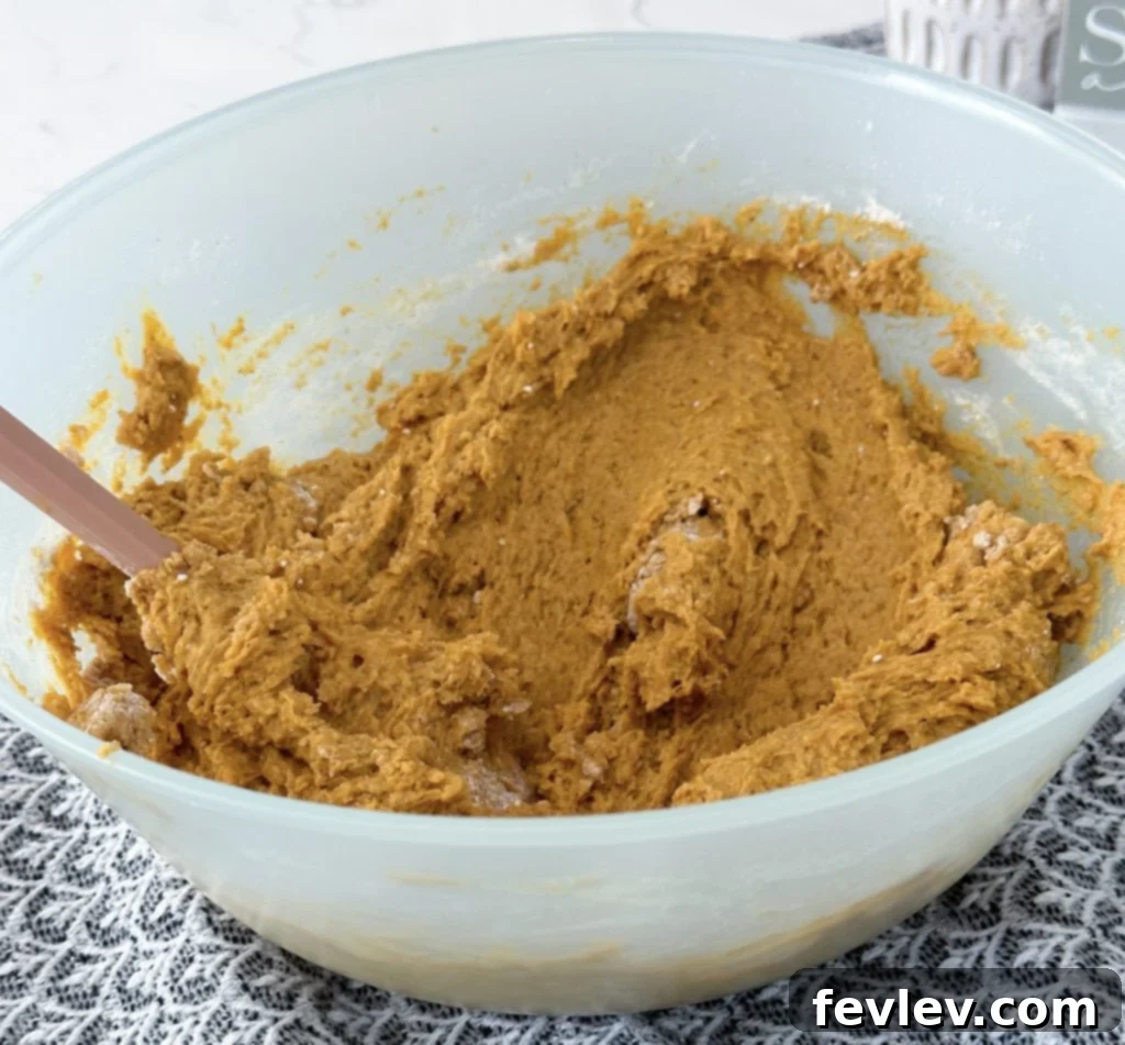 Mixing pumpkin and cake mix for cookies