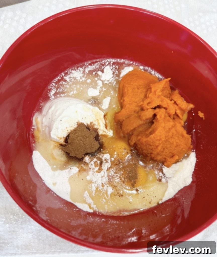 Greasing a 9x13 baking dish for the pumpkin cake