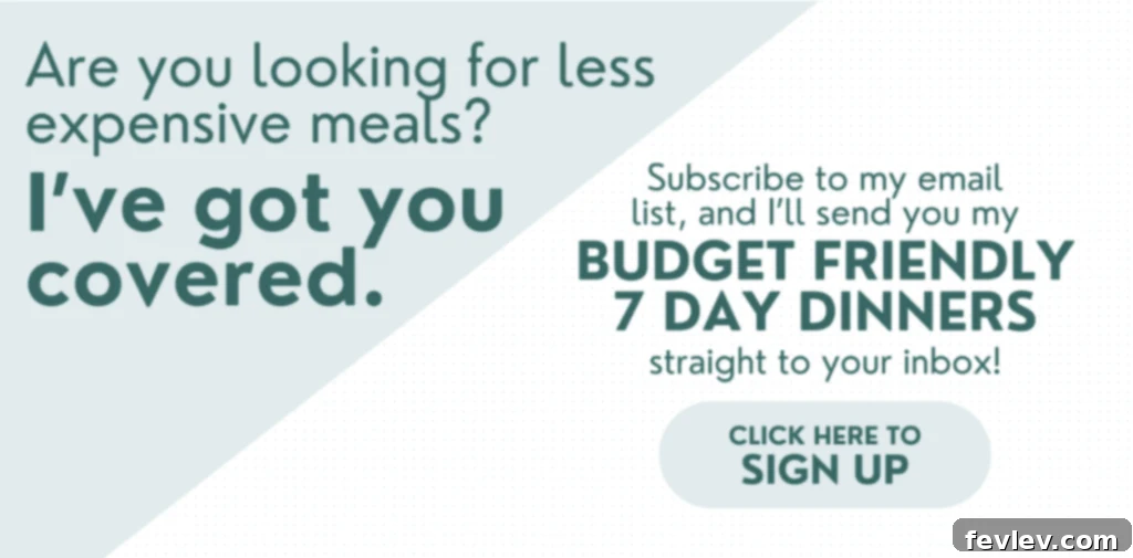 budget friendly dinner recipes - A bowl of pasta with beans in a savory red sauce, garnished with fresh herbs, alongside a slice of garlic bread.