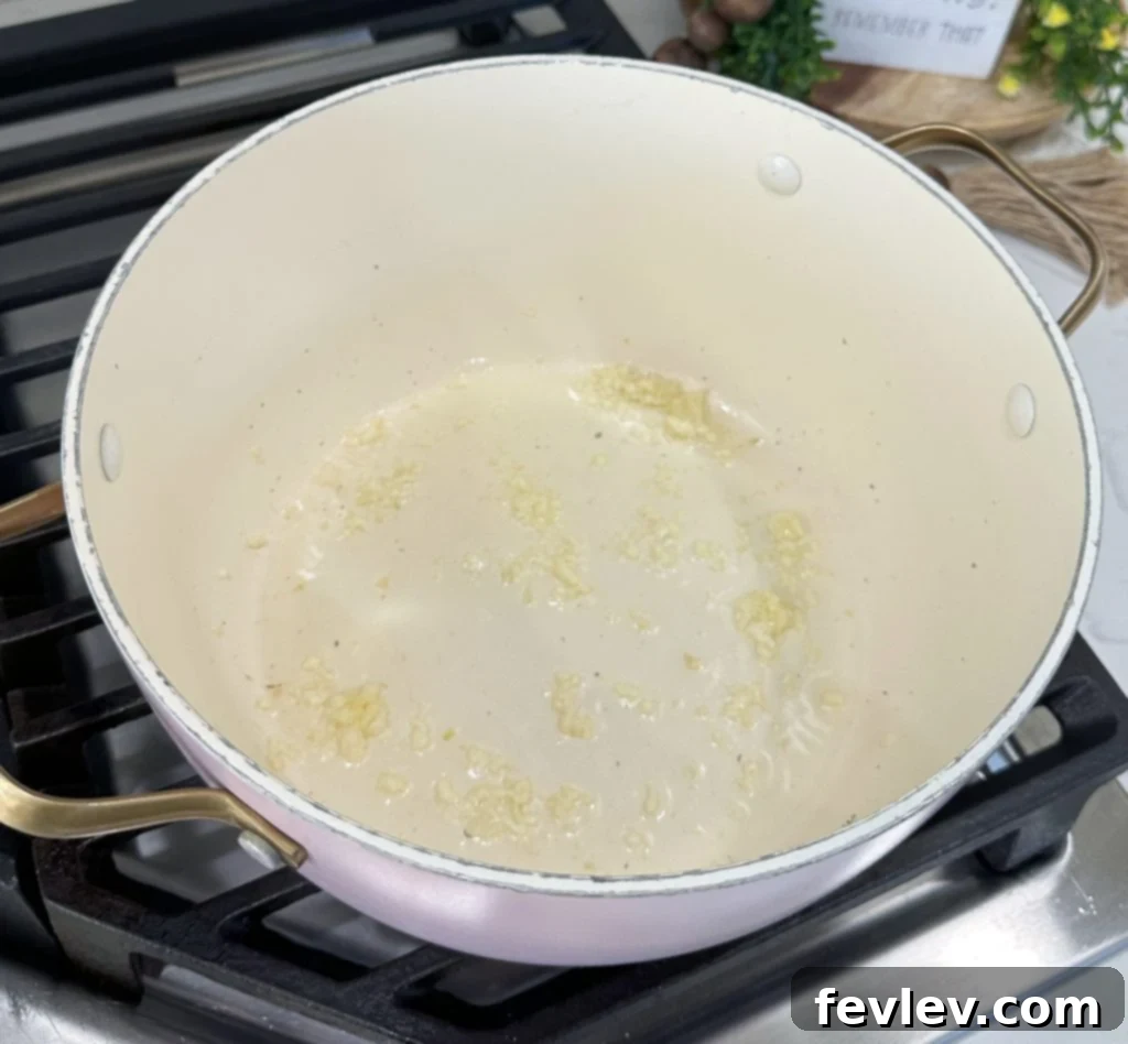 Freshly strained pasta noodles resting in a colander, having just been removed from the hot water.