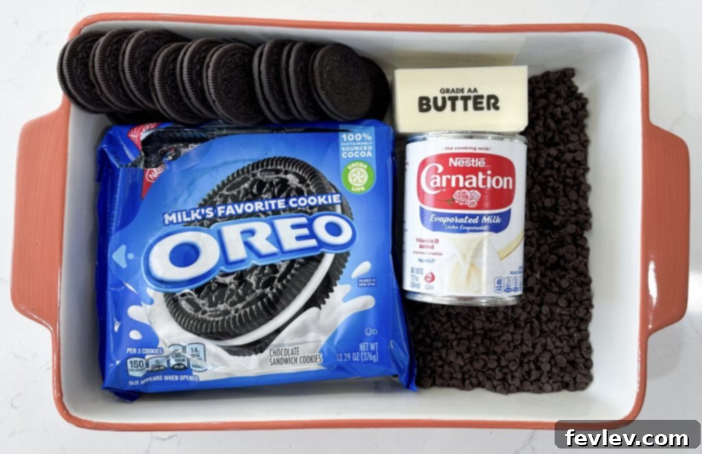 Fresh ingredients for making an Oreo dump cake, including Oreos, cake mix, milk, and butter