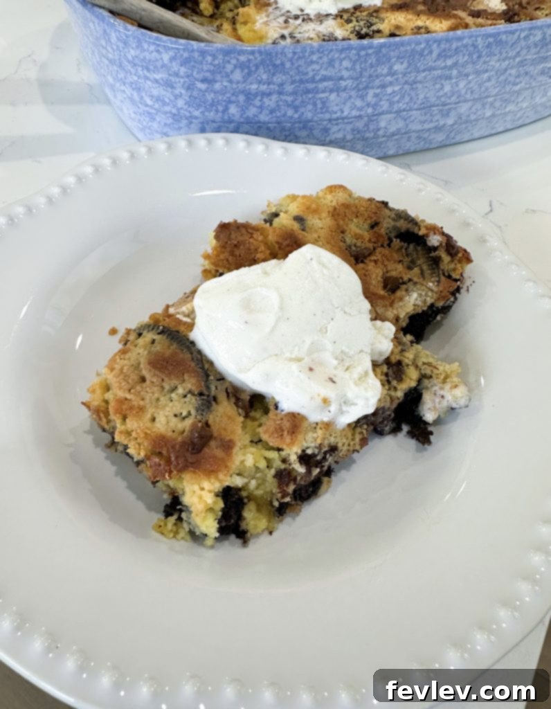Close-up of a slice of Oreo dump cake, showing the cookies and cream layers