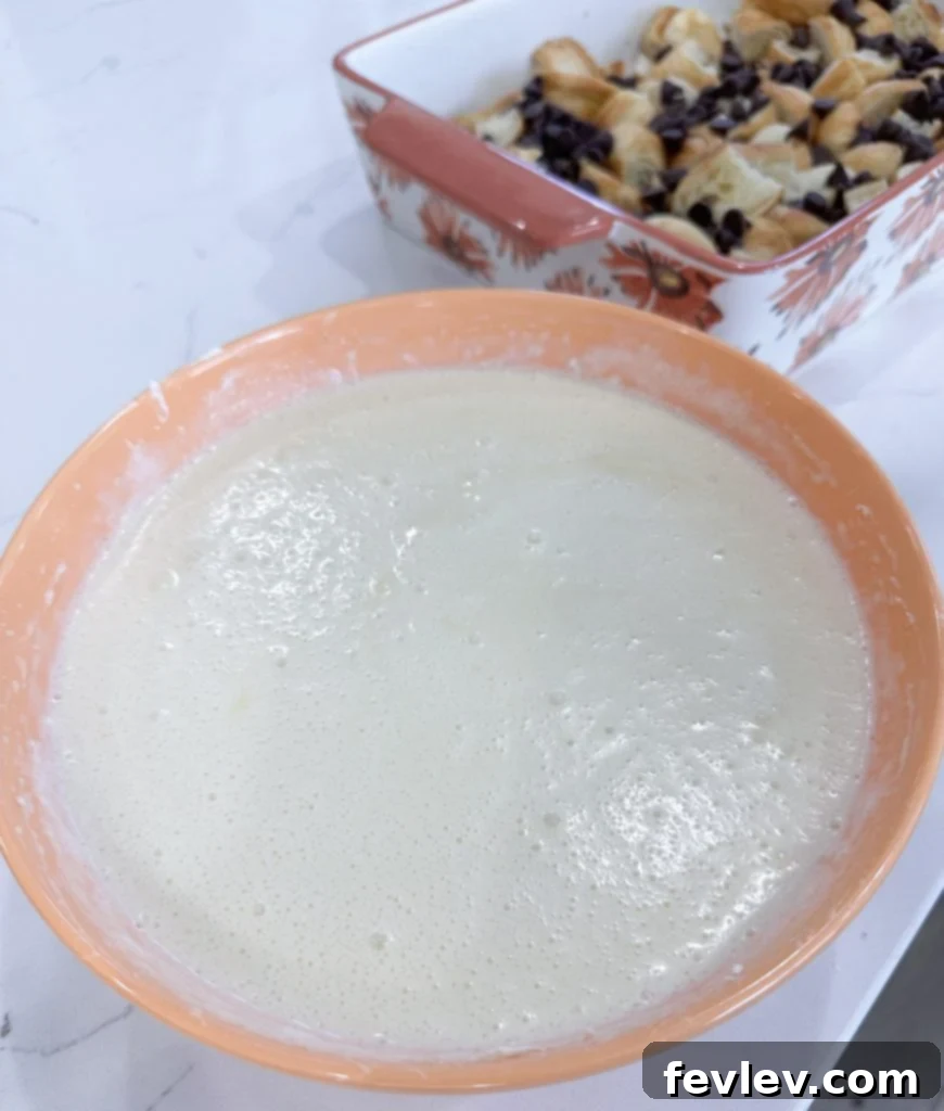 Cream cheese, vanilla, and sugar mixture being prepared for the casserole