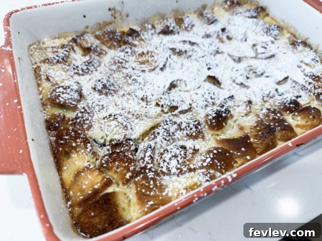 Dump and Bake Chocolate Crescent Casserole dusted with powdered sugar, ready to serve