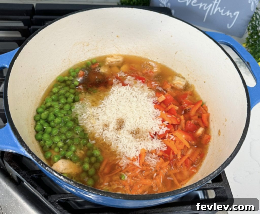 Effortless One-Pot Teriyaki Chicken and Rice 4 All ingredients combined in a pot, ready for simmering to create the teriyaki chicken and rice.