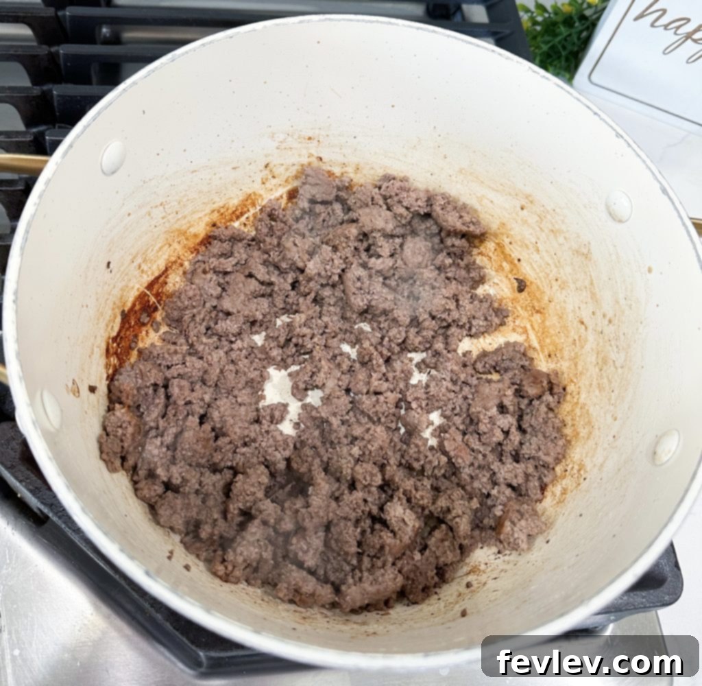 Ground beef cooking in a Dutch oven for One Pot Hamburger Helper