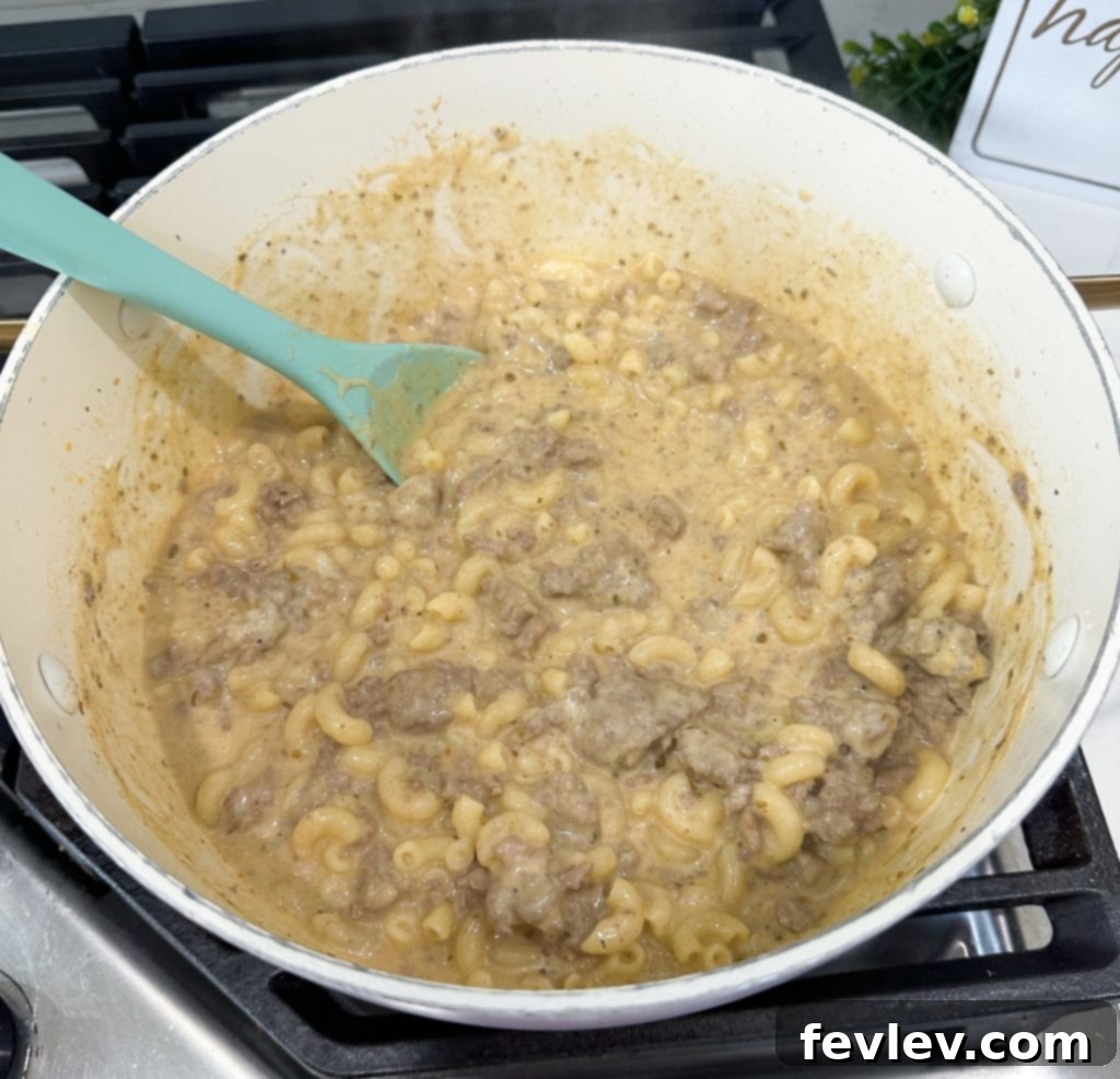 Covered pot simmering, cooking the pasta for Hamburger Helper