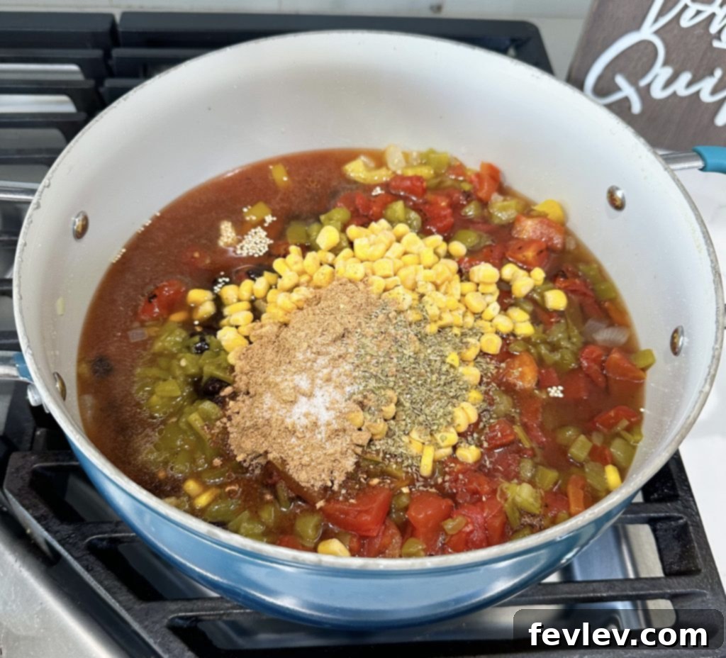 Adding minced garlic to sautéed vegetables