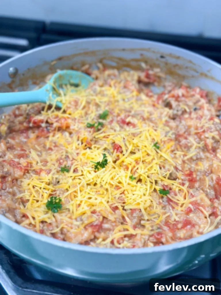 Close-up of hamburger rice casserole simmering, showing tender rice and rich sauce.