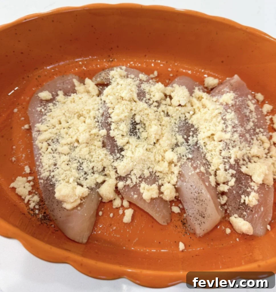 Mayonnaise and grated Parmesan cheese being stirred together in a small bowl.