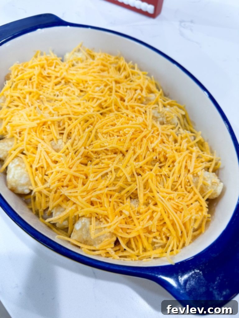 sprinkling cheese on tater tot casserole