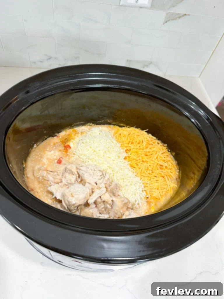 Creamy Slow Cooker Chicken Spaghetti 5 Spaghetti noodles boiling in a pot on the stove, ready to be added to the slow cooker chicken spaghetti.
