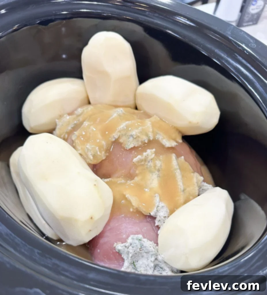Ultimate Slow Cooker Turkey Dinner with Creamy Mash 4 Rubbing herb butter on slow cooker turkey