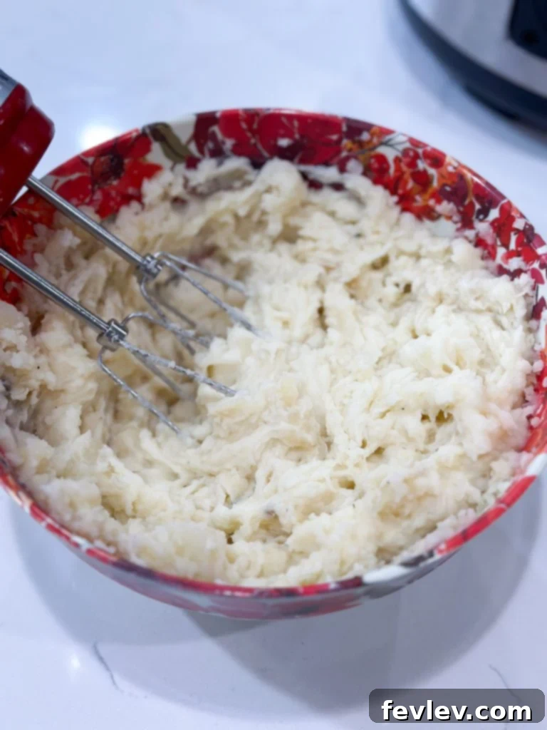 Ultimate Slow Cooker Turkey Dinner with Creamy Mash 7 Homemade gravy being strained