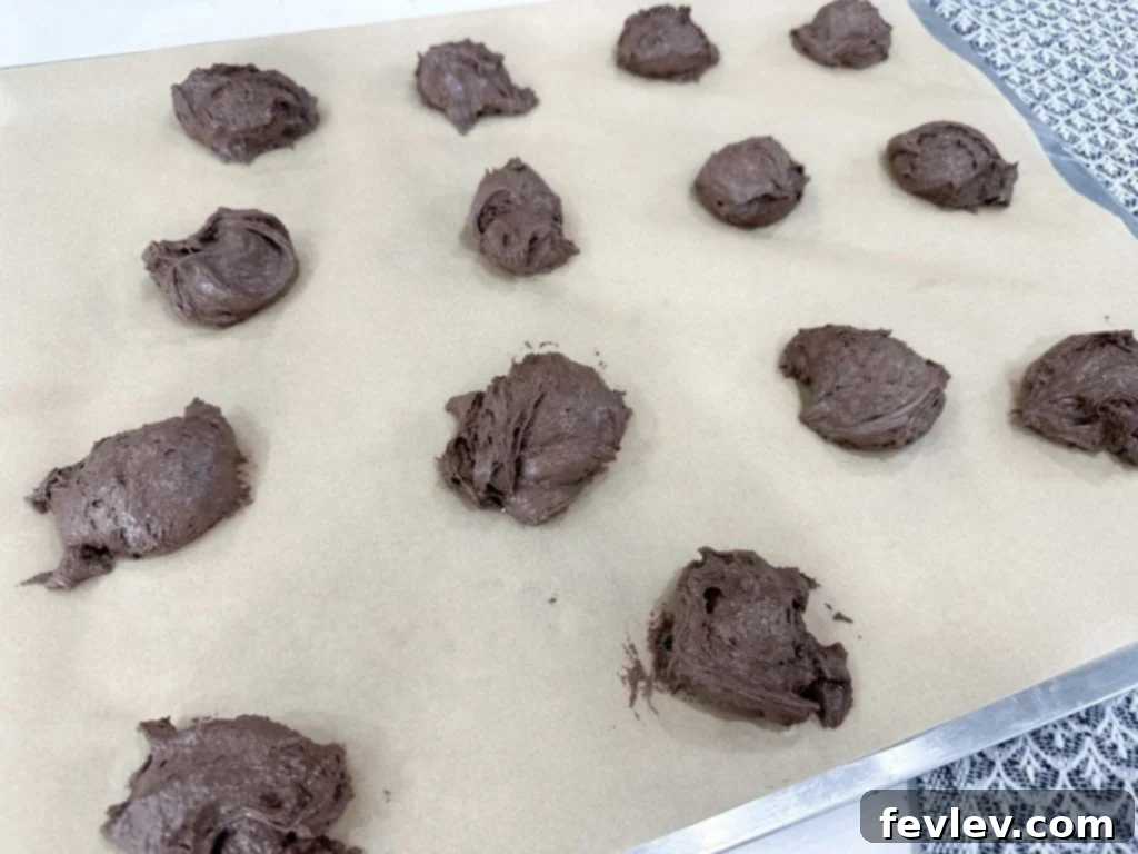 Homemade Oreo cookie sandwiches cooling on a rack
