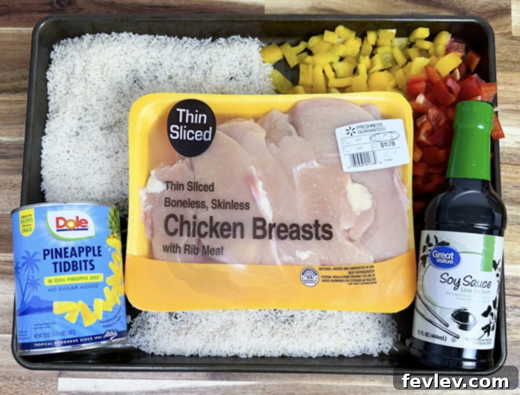 Tropical Sheet Pan Chicken Dinner 2 Easy Sheet Pan Hawaiian Chicken ingredients displayed on a cutting board.