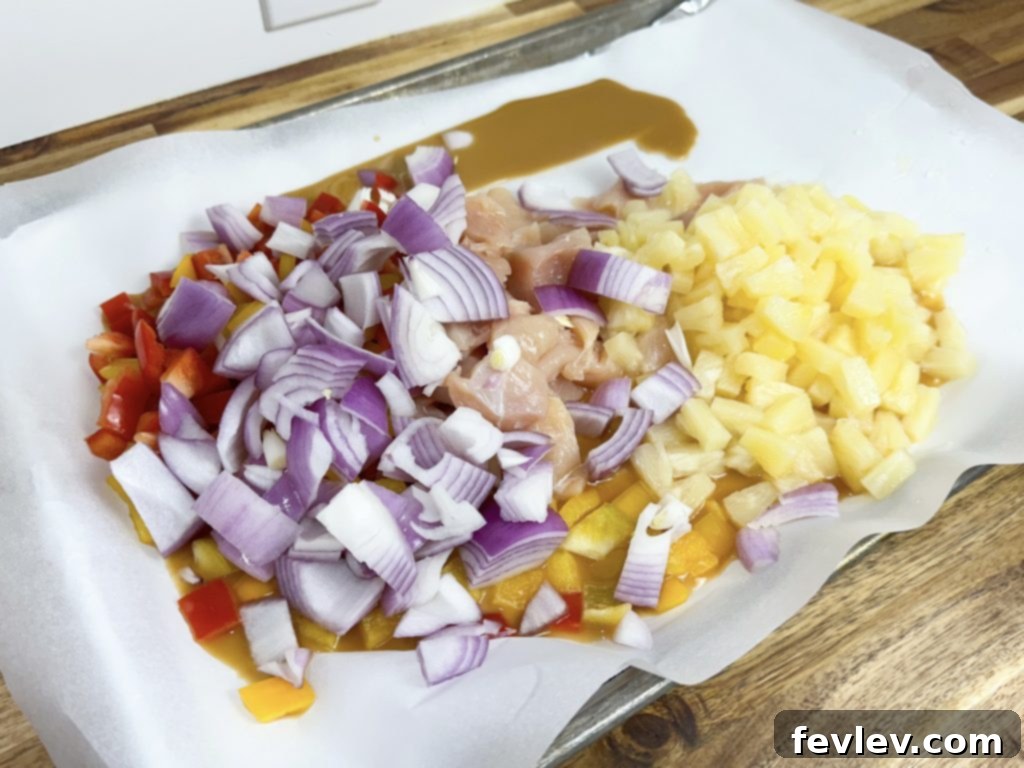 Tropical Sheet Pan Chicken Dinner 3 Preparing the ingredients for Easy Sheet Pan Hawaiian Chicken on a sheet pan.