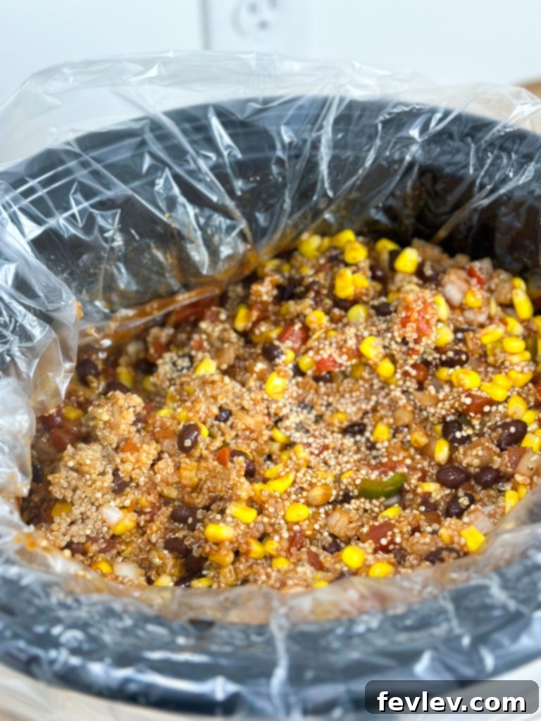 Close-up of cooked Slow Cooker Enchilada Quinoa with melted cheese and fresh cilantro