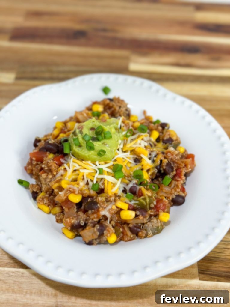 A bowl of Slow Cooker Enchilada Quinoa garnished with cilantro and green onions