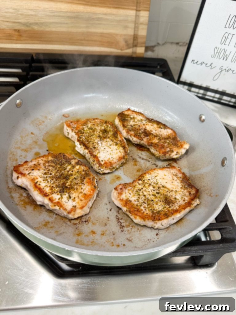 Effortless Pork Chops with Savory Gravy 4 Searing pork chops in a skillet for Easy Pork Chops and Gravy