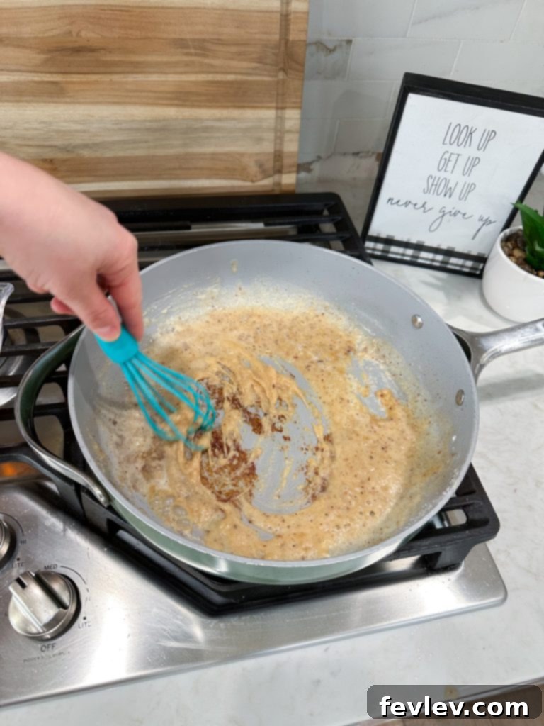 Effortless Pork Chops with Savory Gravy 5 Melting butter for gravy in a skillet