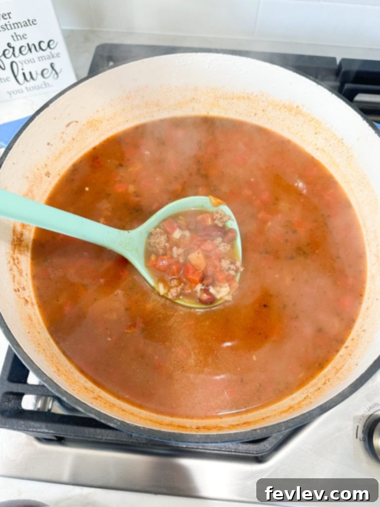Extreme budget dollar dinners: Cooking ground turkey and onions for a chili recipe in a large pot.