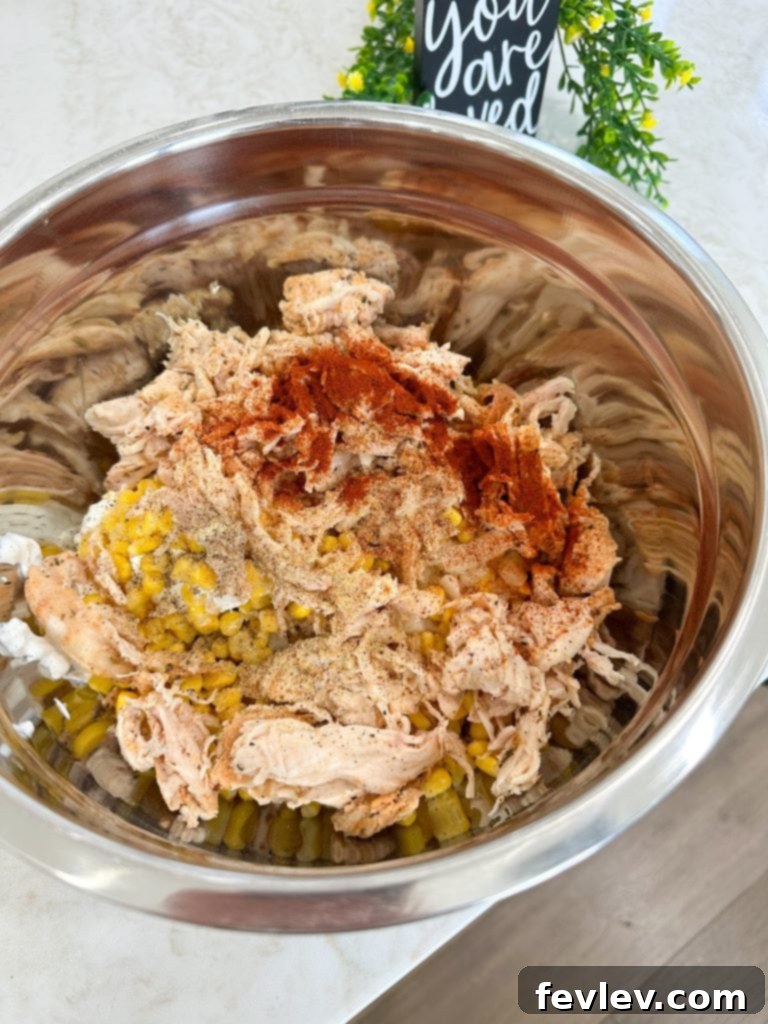 Mixing all ingredients for an easy chicken and vegetable casserole in a large bowl.