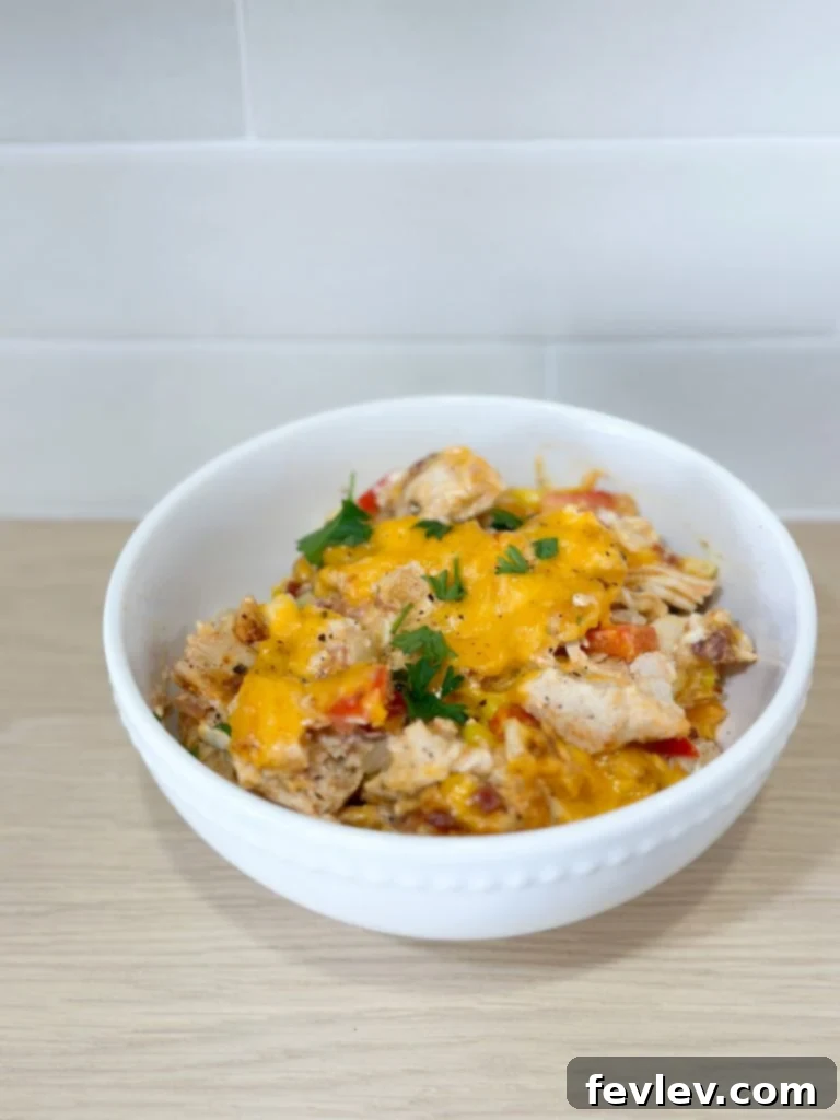 Close-up of a delicious Rotisserie Chicken and Vegetable Casserole with melted cheese topping.
