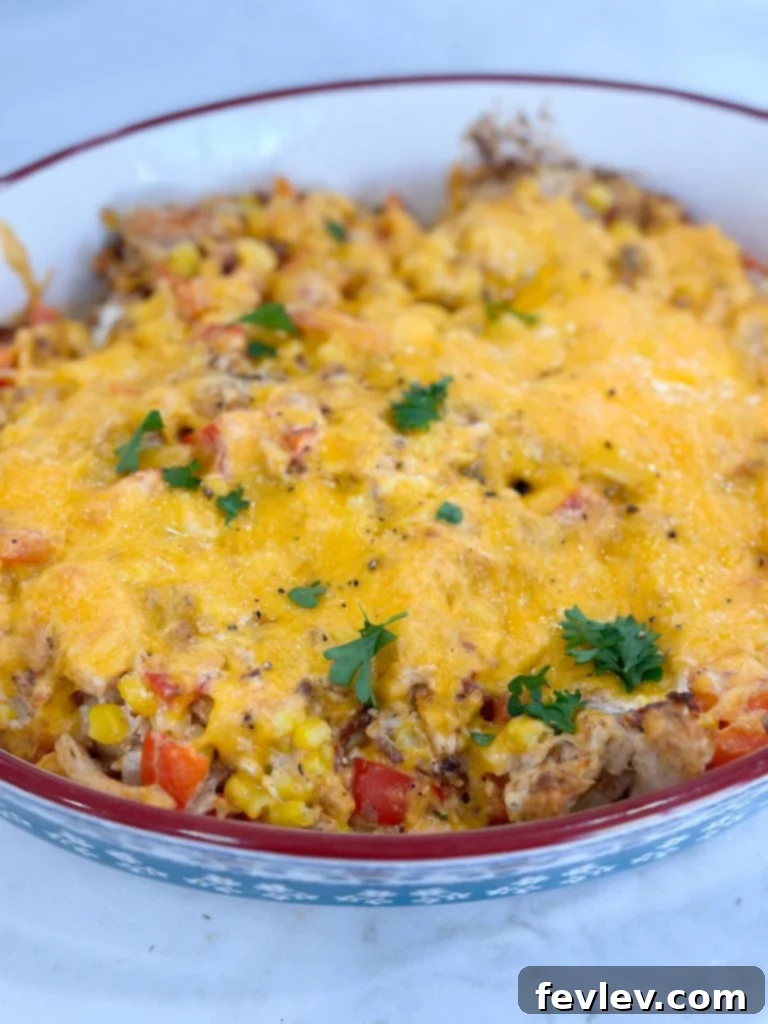 Serving of Rotisserie Chicken and Vegetable Casserole on a plate, garnished with fresh herbs.