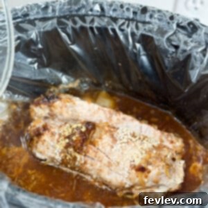 Delicious slow cooker pork tenderloin, sliced and ready to serve, infused with savory flavors