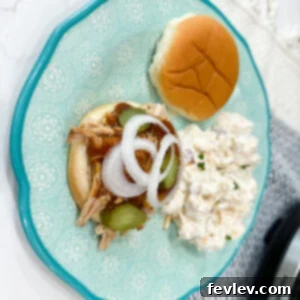 Hearty Barbecue Pulled Pork, shredded and smothered in BBQ sauce, ready for sandwiches
