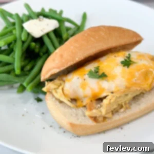 Juicy slow cooker honey mustard chicken, glistening with a sweet and tangy sauce