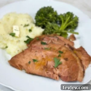 An easy and juicy slow cooker ham, glazed and ready for a holiday dinner or special occasion