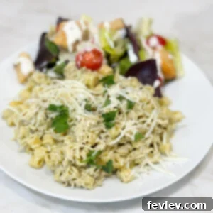 Easy slow cooker pesto chicken, creamy and rich, garnished with fresh herbs