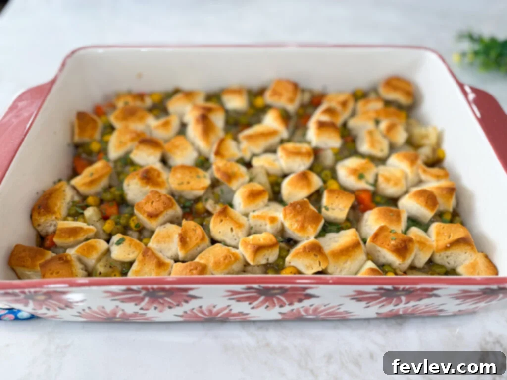Feast for a Month: $45 Budget Dinners and Savvy Grocery Secrets 13 A golden-brown veggie pot pie topped with fluffy biscuits, fresh from the oven, offering a hearty and economical comfort food.