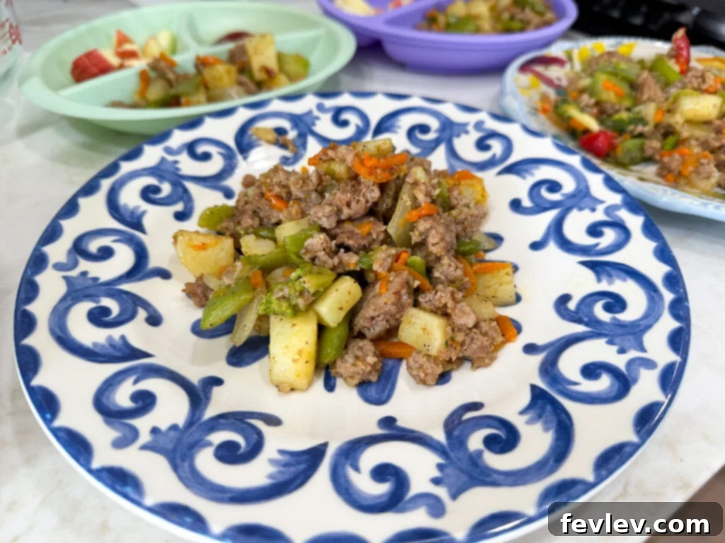 Feast for a Month: $45 Budget Dinners and Savvy Grocery Secrets 17 A vibrant sausage and vegetable stir-fry, rich with spices and colors, cooked in a skillet for a quick and budget-friendly meal.