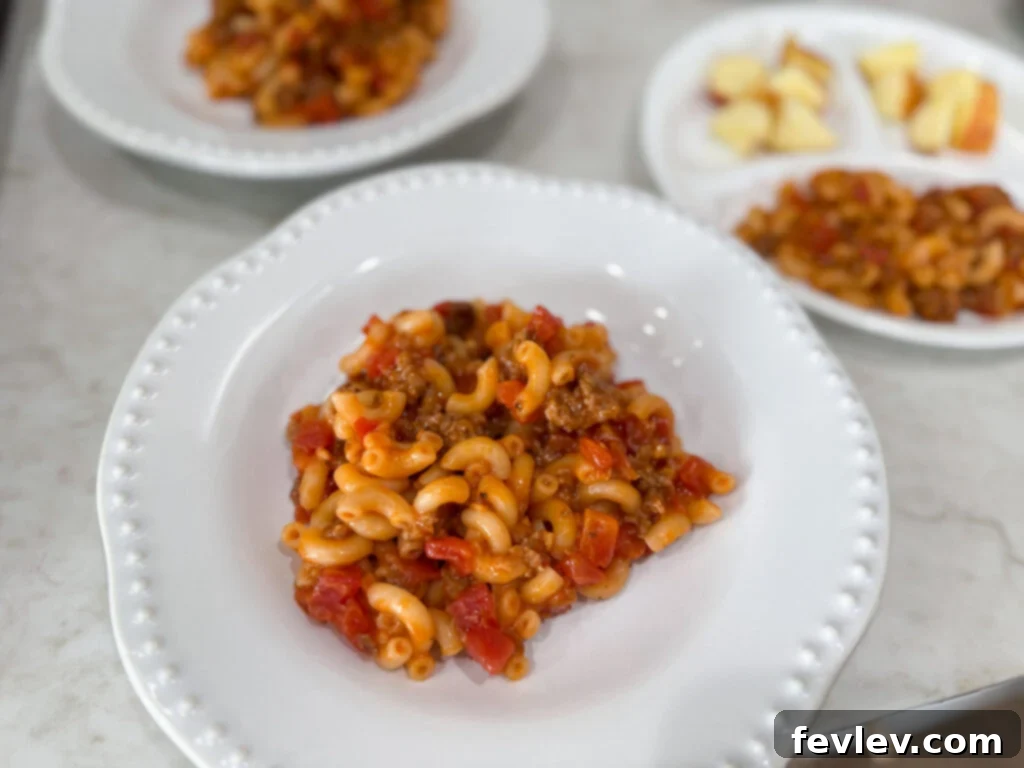 Feast for a Month: $45 Budget Dinners and Savvy Grocery Secrets 18 A rich and creamy sausage mac and cheese, combined with diced tomatoes, offering a hearty and budget-friendly twist on a classic.