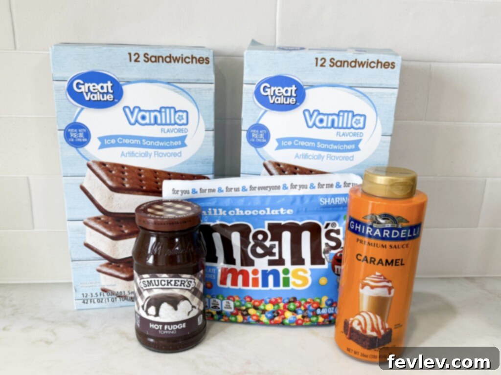The simple ingredients laid out for a delicious ice cream sandwich cake recipe, including ice cream sandwiches, hot fudge, whipped topping, and M&M's.
