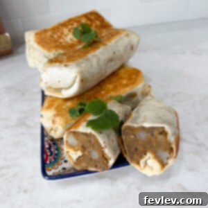 Lentil burritos stacked up on a plate, ready to be served.