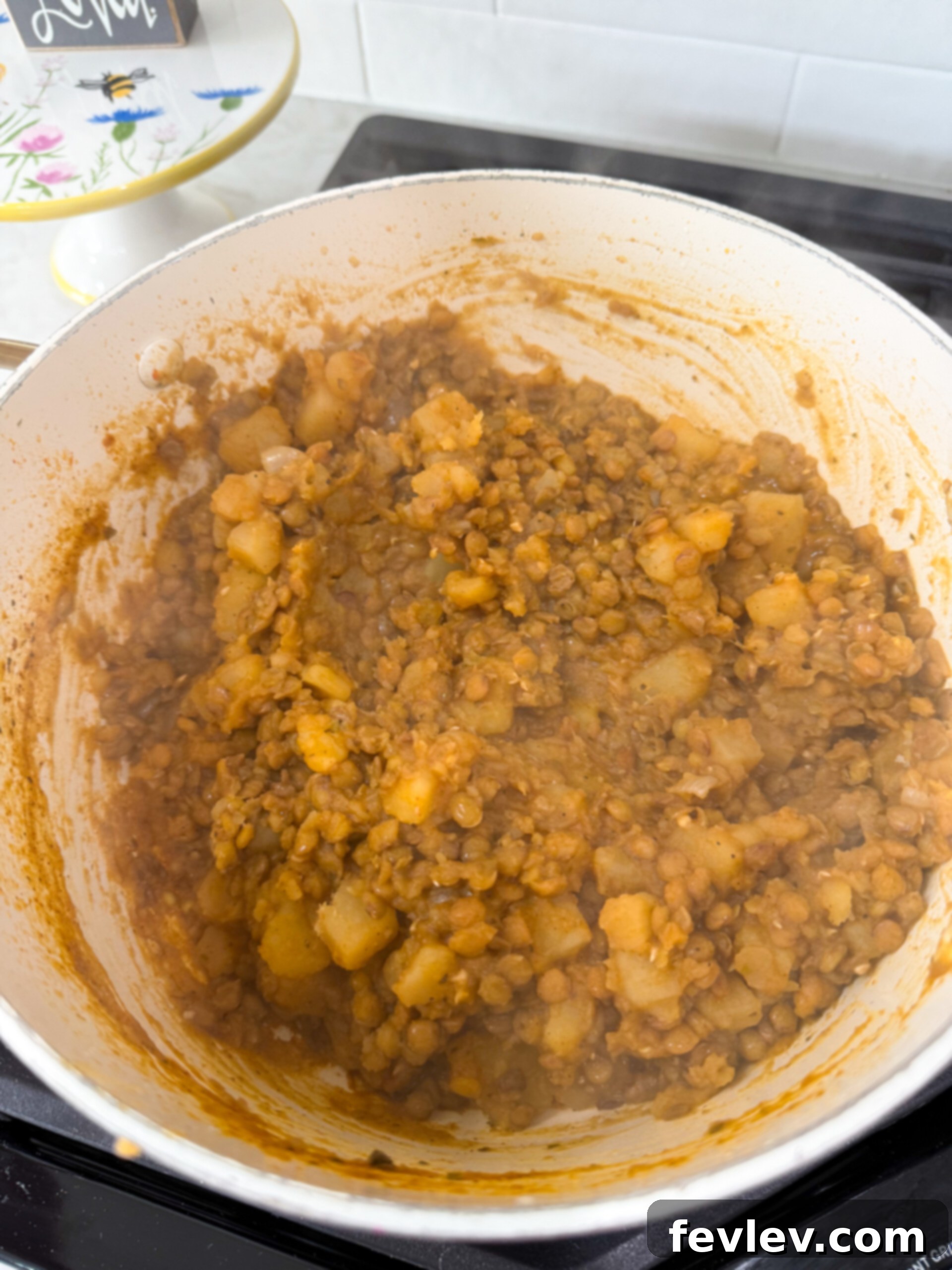 A close-up of the flavorful lentil and potato burrito filling in a pot, ready for assembly.