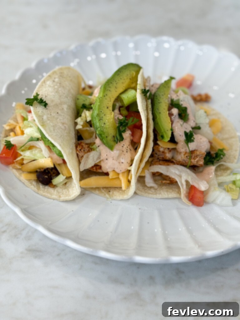 Assembled chicken taco wrap with creamy salsa ranch ready for serving